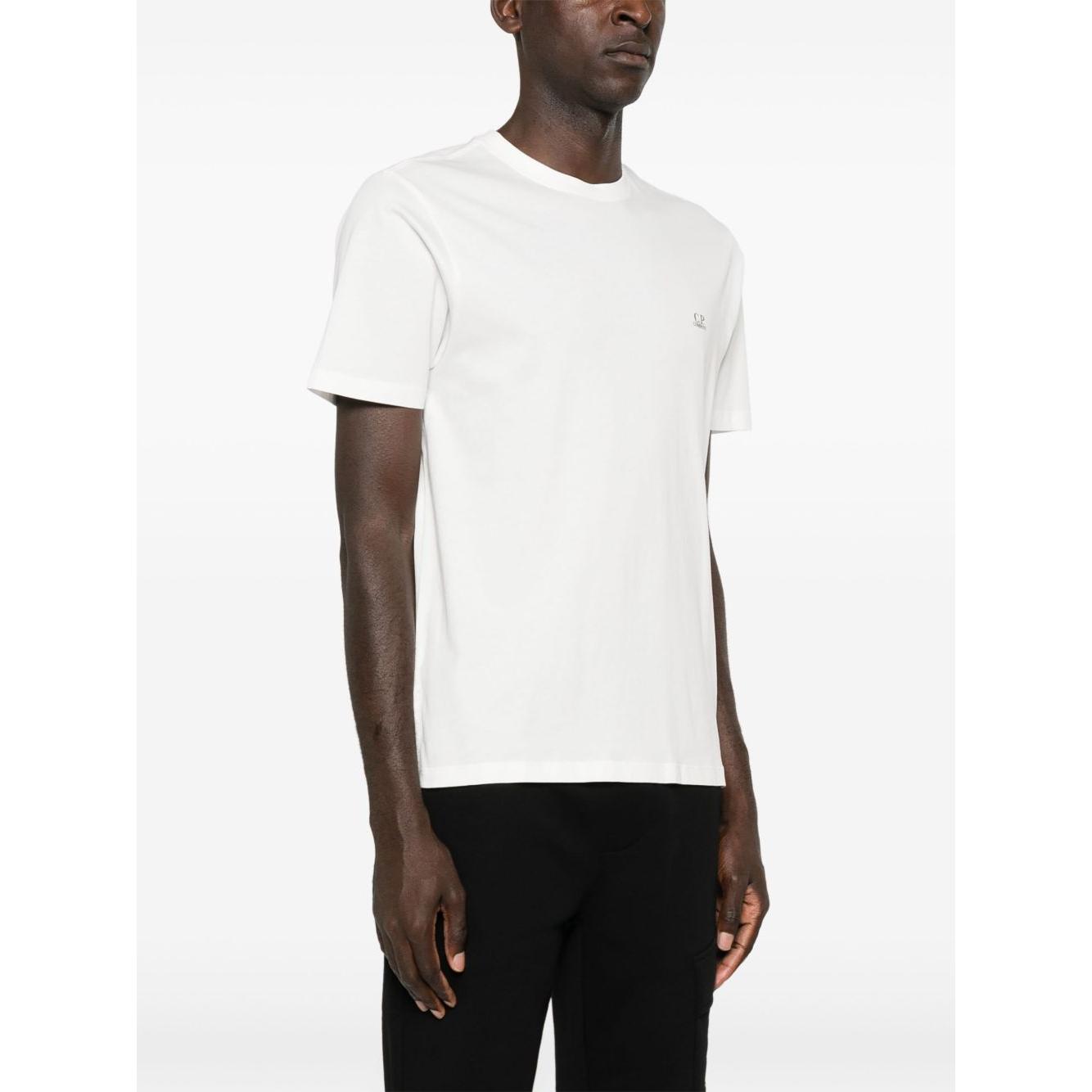 Man wearing C.P. Company optical white cotton t-shirt with crew neck, short sleeves, logo print on chest, and Goggle print on back.