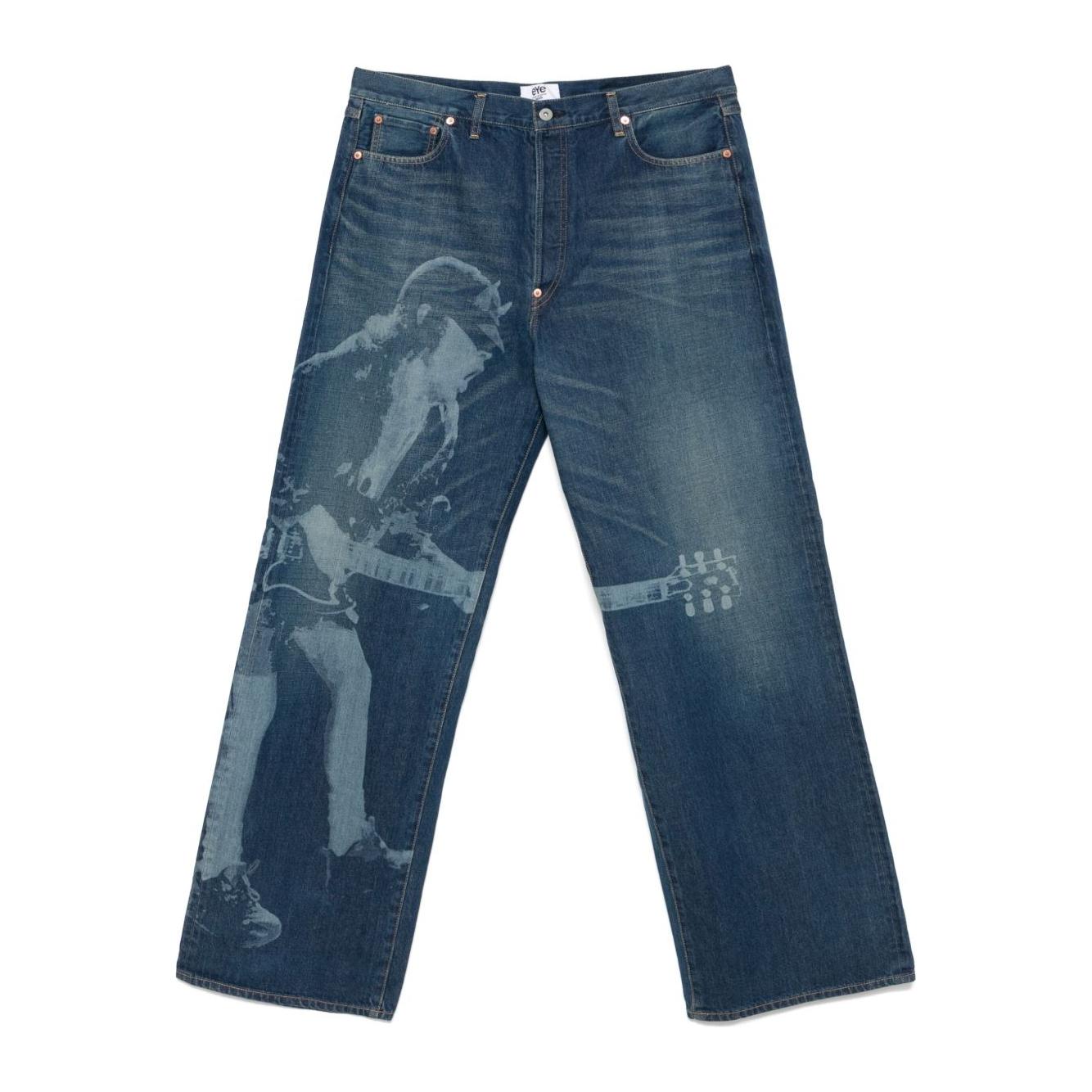 Indigo blue Junya Watanabe jeans with printed guitarist, button fly, belt loops, and adjustable rear strap, classic five-pocket style.