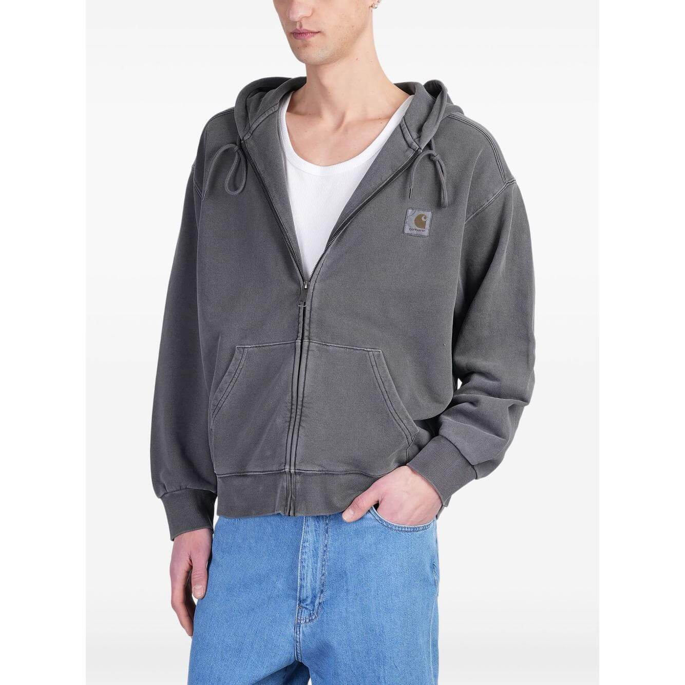 Carhartt WIP grey hoodie with concealed front zip, drawstring hood, and side pockets, worn by model. Cotton, true to size.