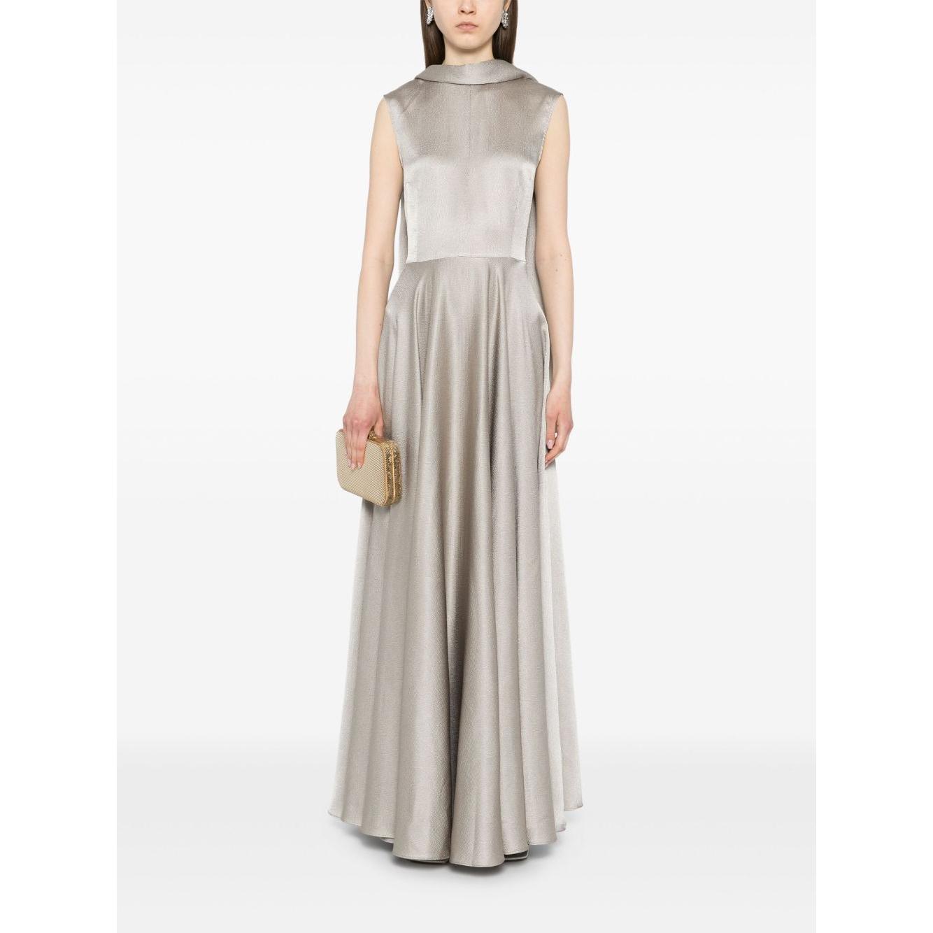 Model wearing Solace London ash grey sleeveless Emelia maxi dress with scarf detail, flared skirt, and concealed rear fastening, holding a clutch.
