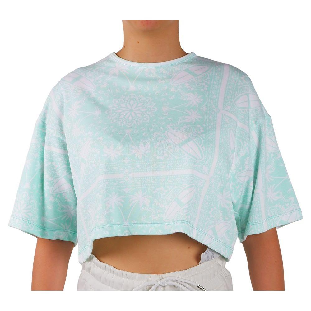 Person wearing a cropped pastel green t-shirt with abstract patterns and short sleeves.