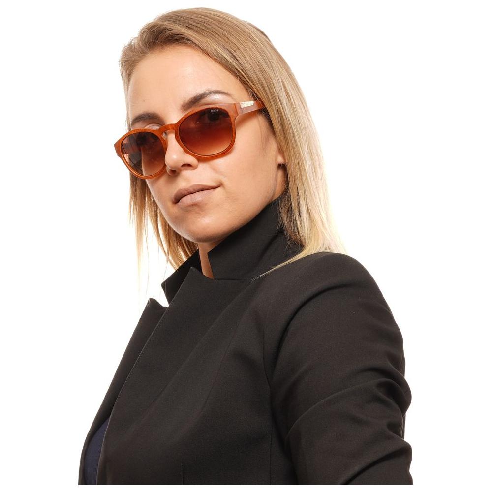 Person wearing Bolle Brown Unisex Sunglasses with full-rim round frames and gradient lenses for UVA & UVB protection.