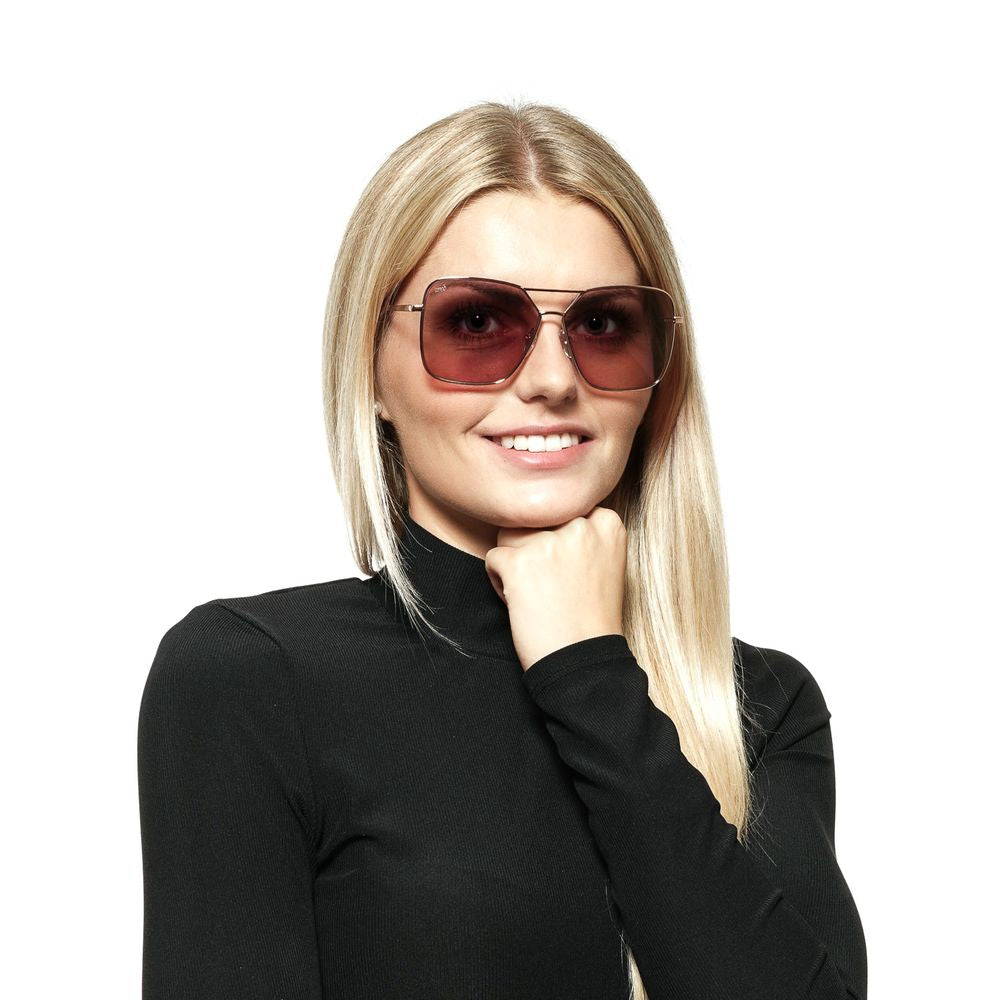 Web rose gold women's sunglasses with mirrored purple lenses and metal frame, worn by a woman in a black turtleneck.