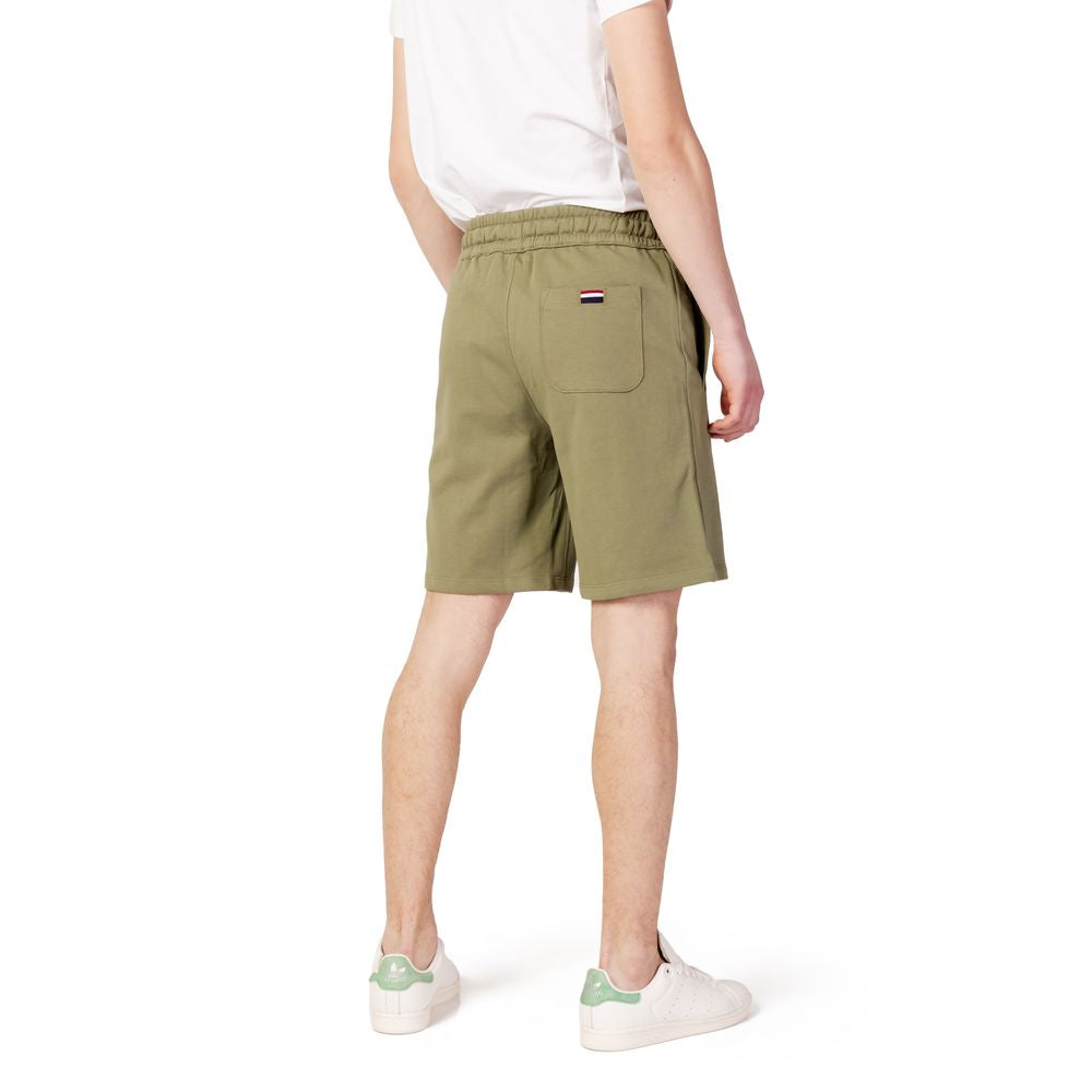 Back view of man wearing U.S. POLO ASSN. green cotton Bermuda shorts from the Spring/Summer collection, showcasing stylish casual wear.