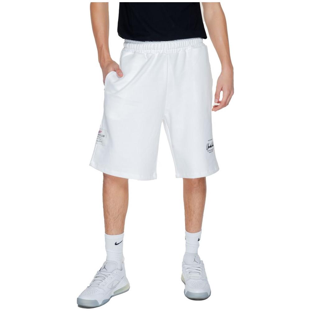 Man wearing Underclub white cotton Bermuda shorts from the spring/summer collection, featuring relaxed fit and drawstring waist.