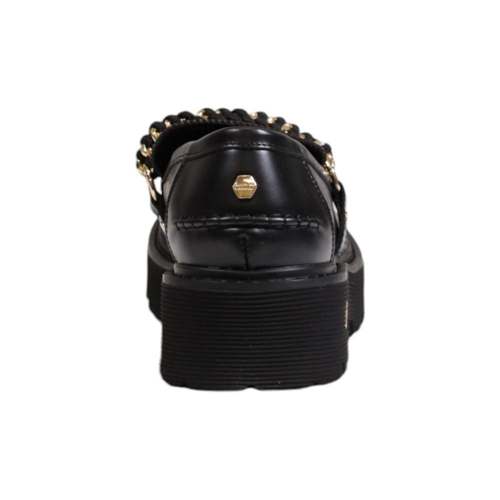 Rear view of women's Cult black leather flat shoe, showcasing gold-tone chain detail. Ideal for fall/winter. 100% leather composition.