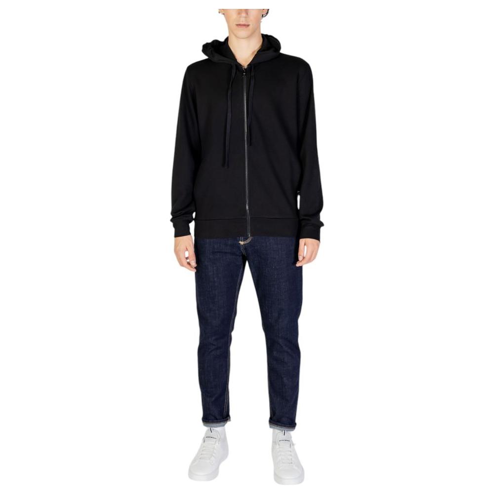 Emporio Armani Underwear black polyester men's hoodie with zip closure, perfect for casual outings, shown on model wearing jeans and sneakers.