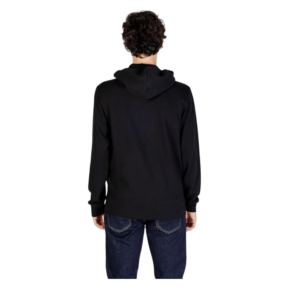 Back view of a man wearing an Emporio Armani Underwear black polyester hoodie with jeans, showing a casual and modern design.