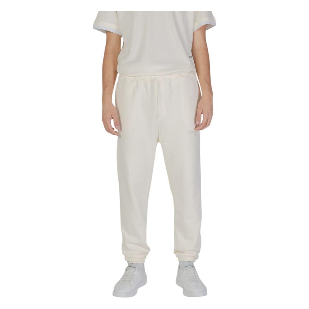 Model wearing Underclub cream cotton pants for men, part of fall/winter collection, made from 100% cotton.