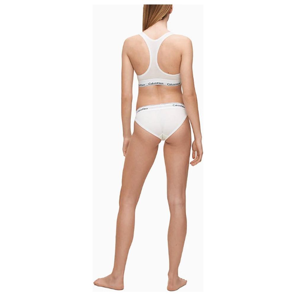 Back view of woman wearing Calvin Klein white cotton underwear set with logo waistband
