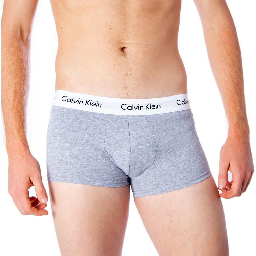 Model wearing Calvin Klein gray cotton underwear with elastic waistband for optimal fit and comfort.