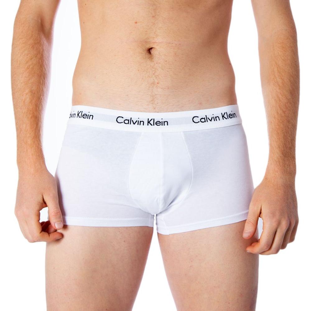 Man wearing Calvin Klein white cotton trunks showcasing elastic waistband fit and comfort.