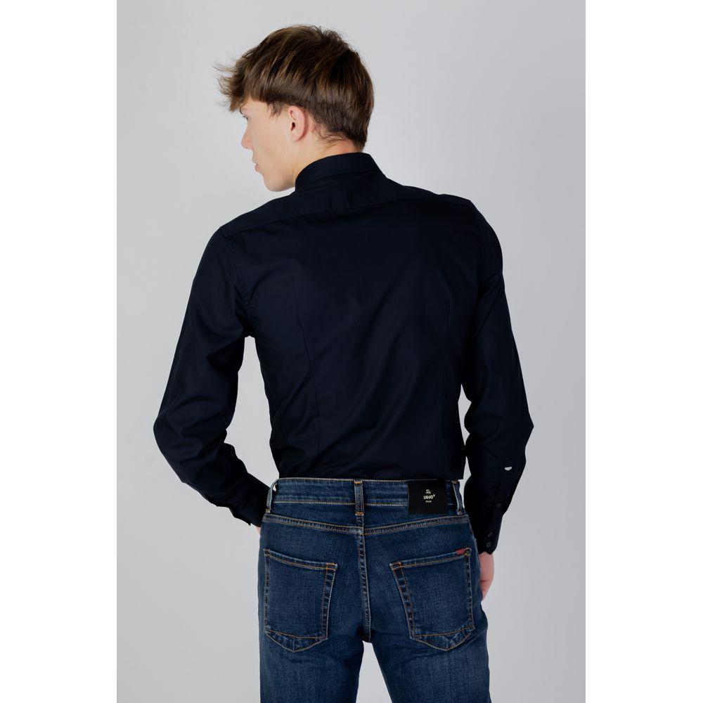 Back view of model wearing Antony Morato blue cotton shirt paired with jeans, highlighting the shirt's versatile and elegant design.