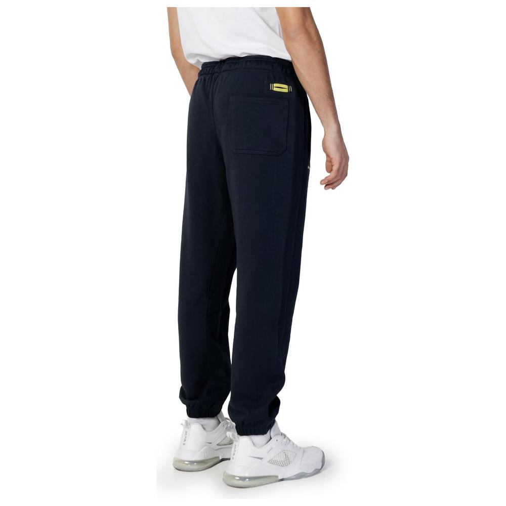 Man wearing Blauer blue cotton jeans from spring/summer collection. Men's sport pants made of 100% cotton. Back view.