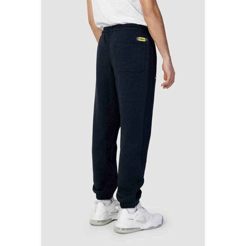 Back view of men’s Blauer blue cotton sport pants, spring/summer collection, paired with white sneakers.
