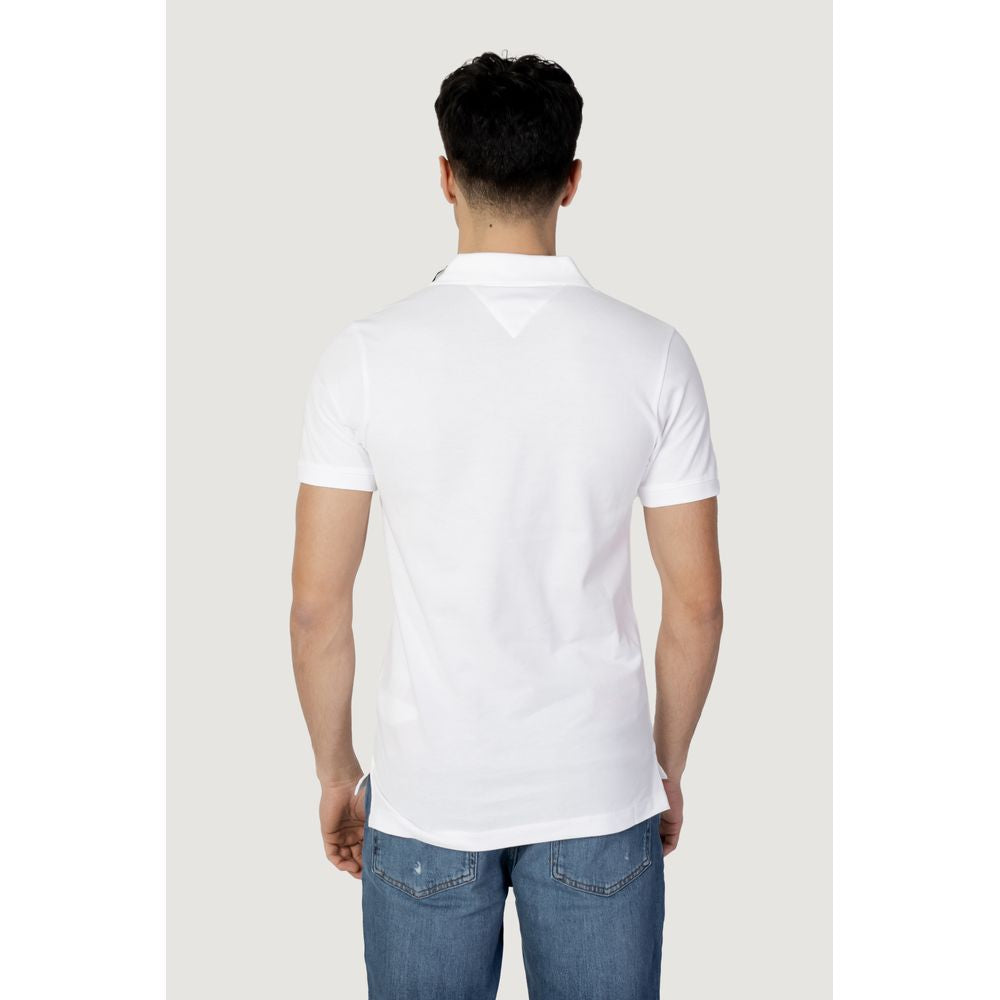 Back view of Tommy Hilfiger white cotton polo shirt from Fall/Winter collection, paired with jeans, showcasing men's fashion style.