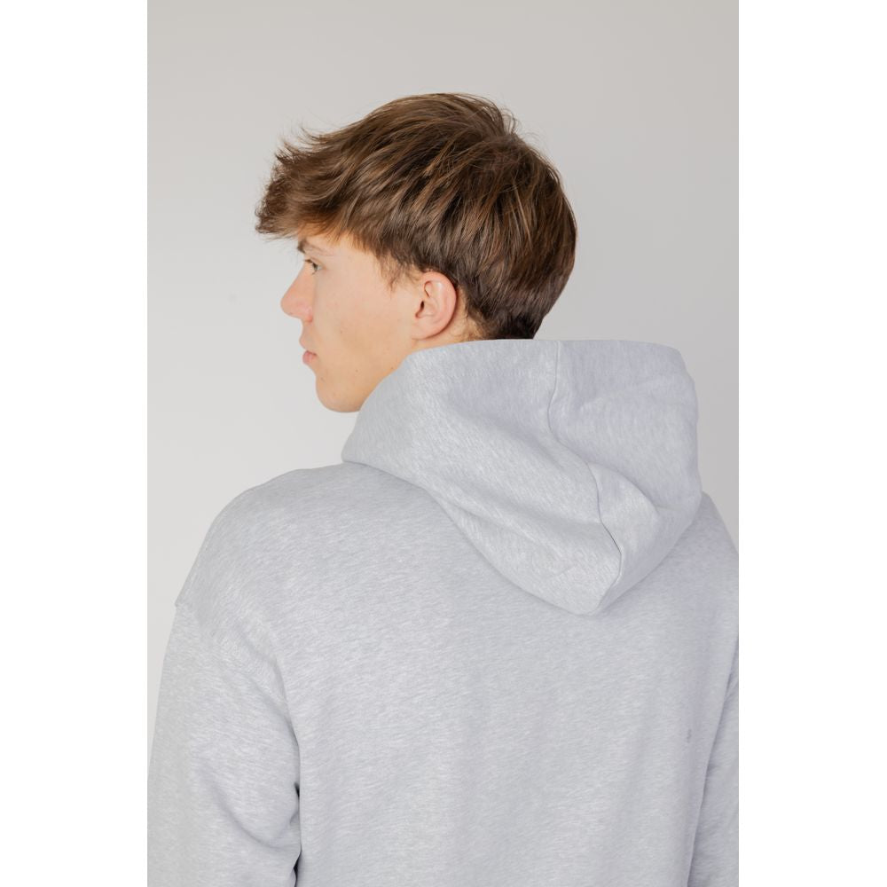 Back view of a man wearing an Underclub gray cotton hoodie, autumn/winter collection, featuring a soft hood design.