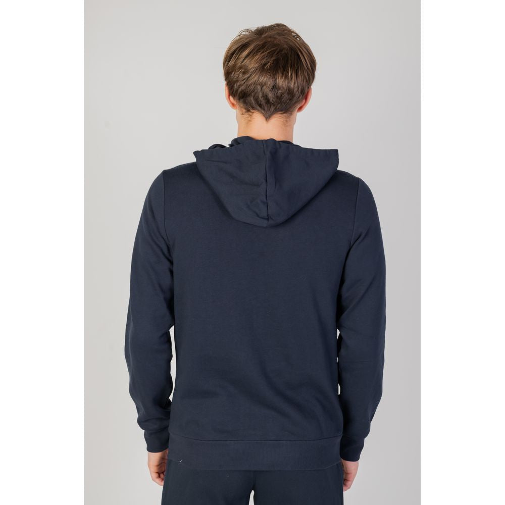 Back view of a man wearing a blue Emporio Armani cotton hooded sweatshirt, showcasing its casual style and comfortable fit.