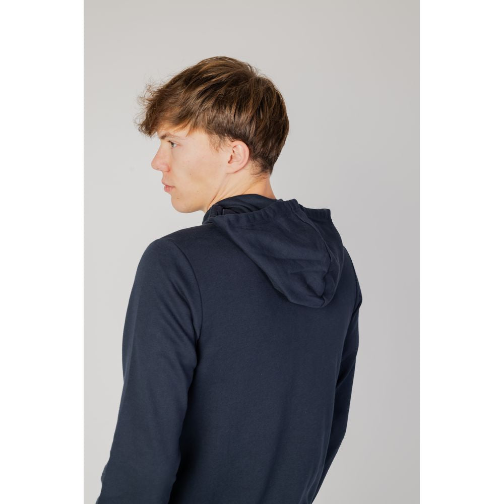 Man wearing Emporio Armani Underwear blue cotton sweater with hood, showcasing back and design detail.