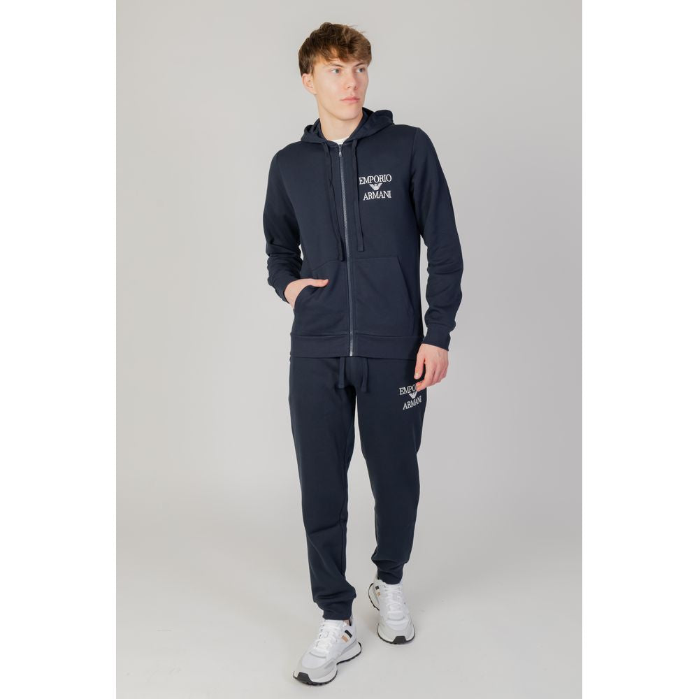Model wearing Emporio Armani Underwear blue cotton hoodie with zip and logo, featuring side pockets, perfect for casual wear.
