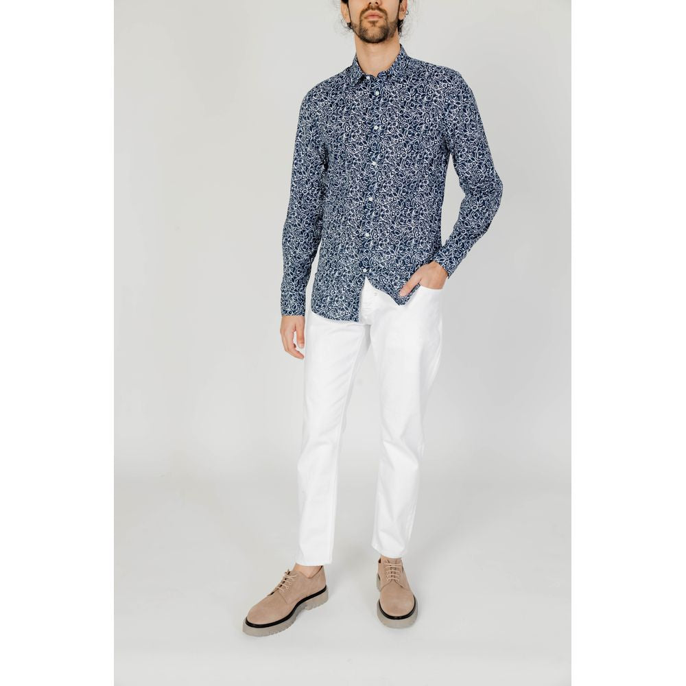 Antony Morato men's long sleeve blue cotton shirt, part of the Spring/Summer collection, paired with white pants and beige shoes.