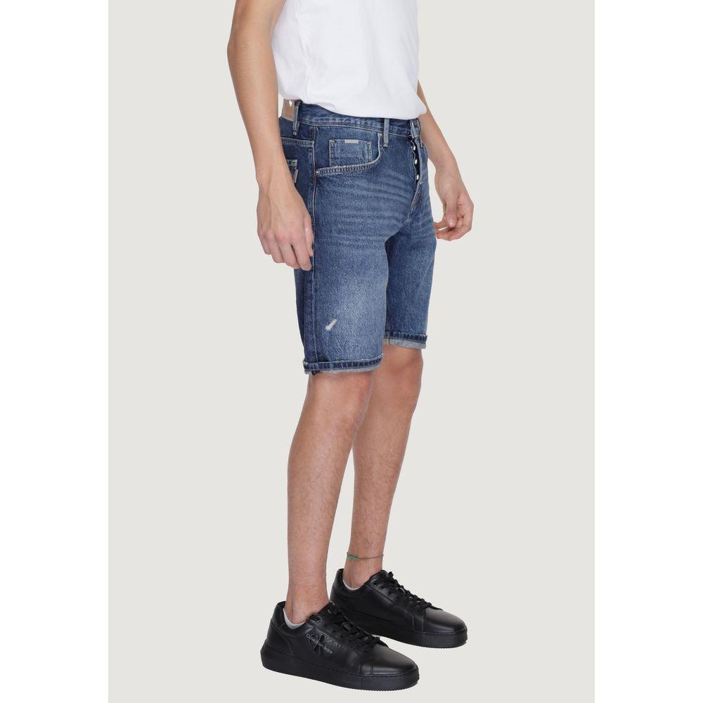 Model wearing Antony Morato blue cotton Bermuda shorts from Spring/Summer collection, side view, paired with black sneakers.