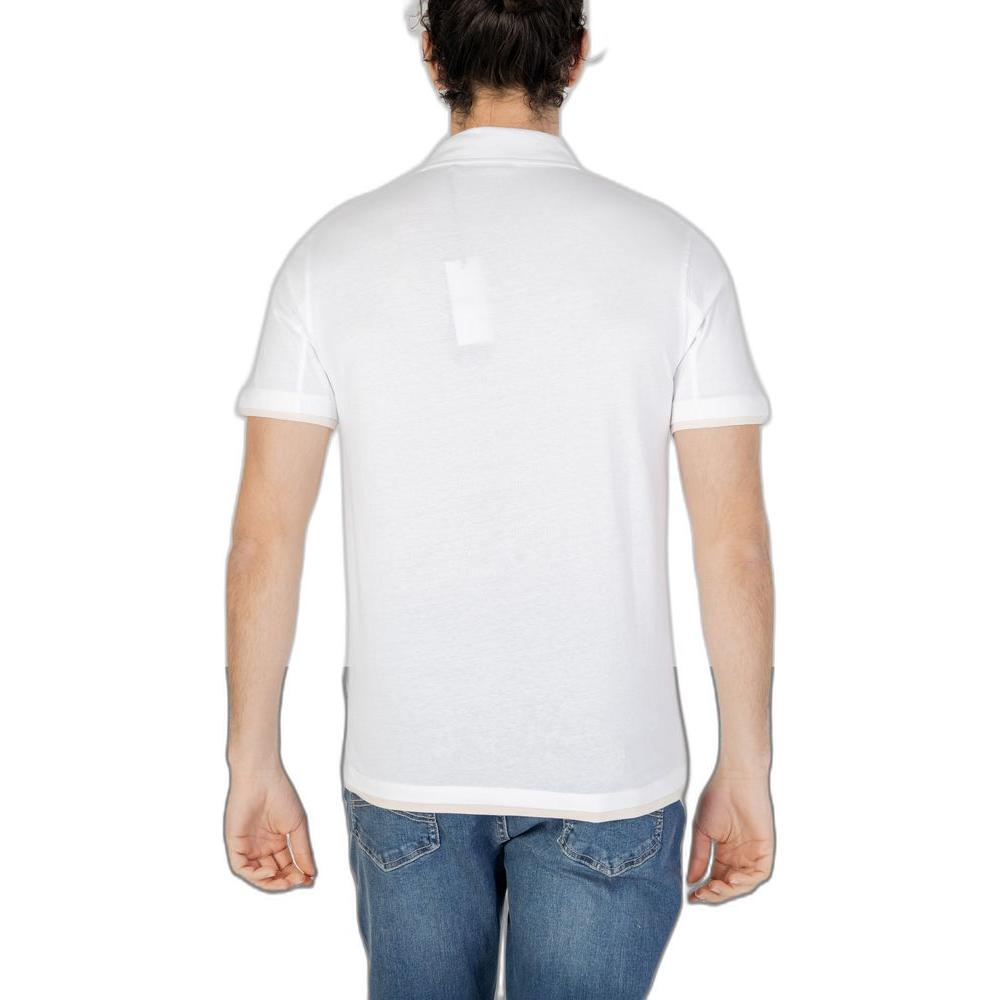 Back view of man wearing Hamaki-Ho white cotton short sleeve polo shirt from Spring/Summer collection, paired with jeans.