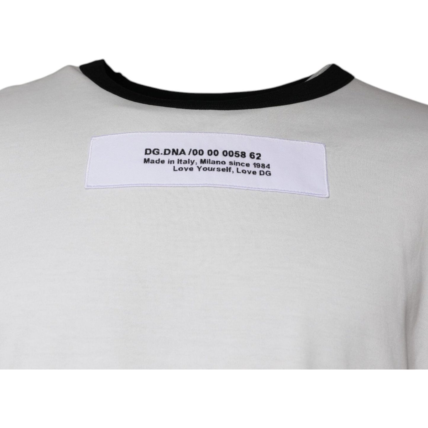 Close-up of Dolce & Gabbana white t-shirt back detail with label, showing model number and 'Made in Italy, Milano since 1984' text.