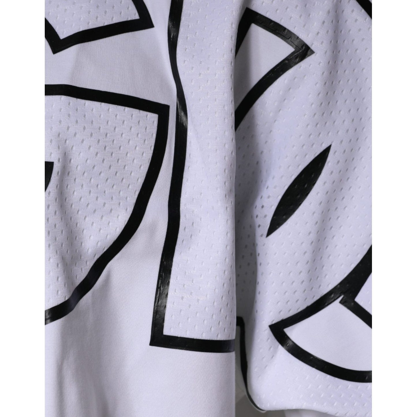 Close-up of Dolce & Gabbana white crew neck t-shirt with black logo print, featuring short sleeves and minor front stains.