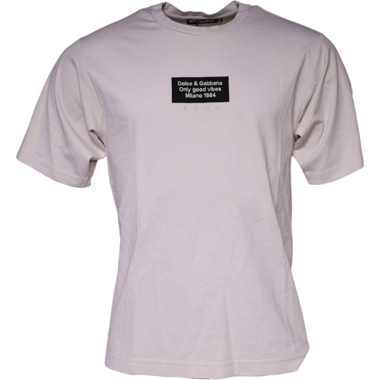 Dolce & Gabbana beige cotton blend crew neck t-shirt with logo graphic and short sleeves. Fashionable men's tee, made in Italy.