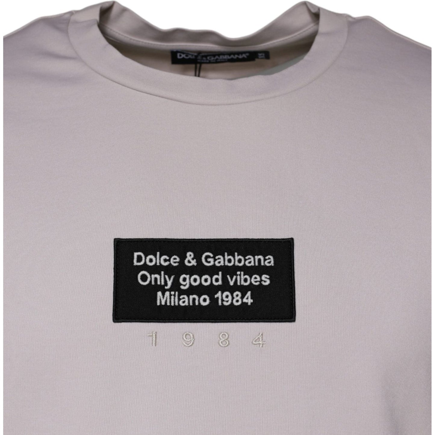 Dolce & Gabbana beige crew neck t-shirt with logo print, 1984 graphic, short sleeves, made in Italy, minor stains, missing tag.