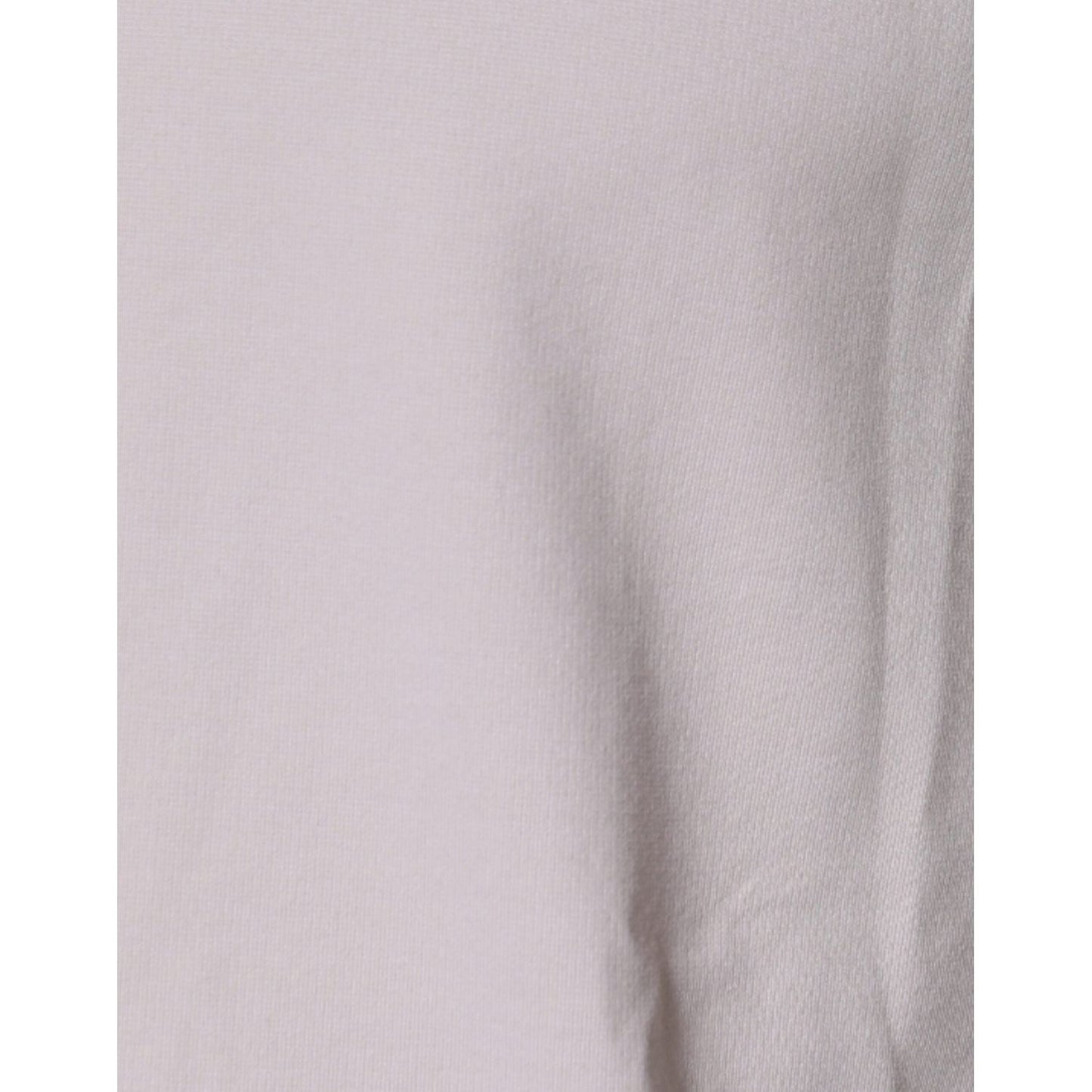 Close-up of the beige fabric texture of a Dolce & Gabbana crew neck t-shirt showing a subtle stain.