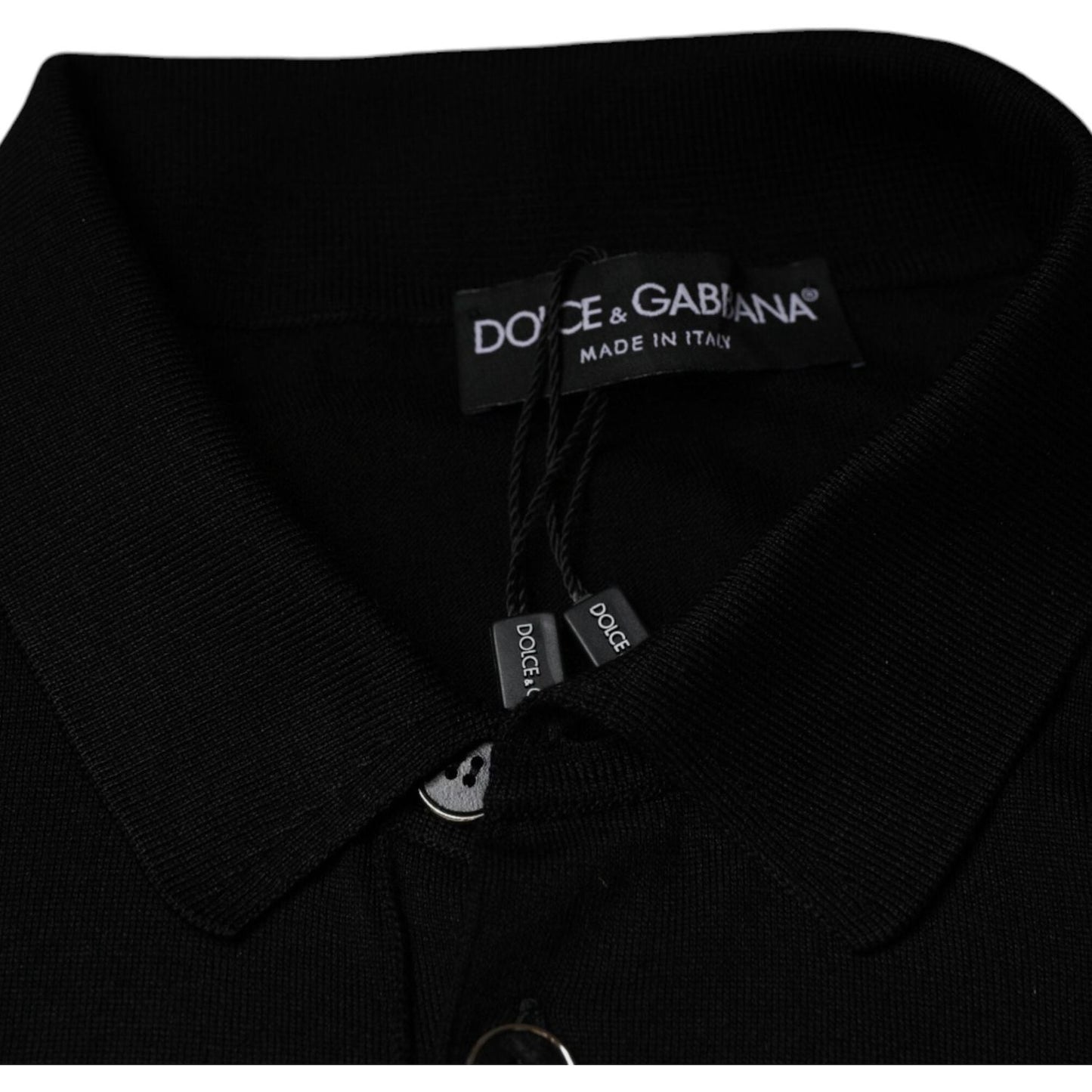 Dolce & Gabbana black silk polo shirt collar with brand label, showing collared neck and part of button closure, made in Italy.