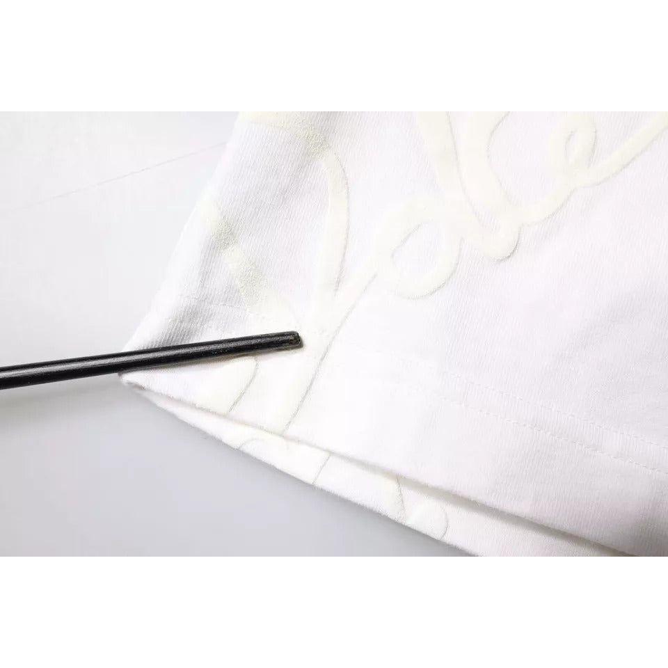 Close-up of Dolce & Gabbana white t-shirt featuring logo print with visible pen marks and stains on fabric.