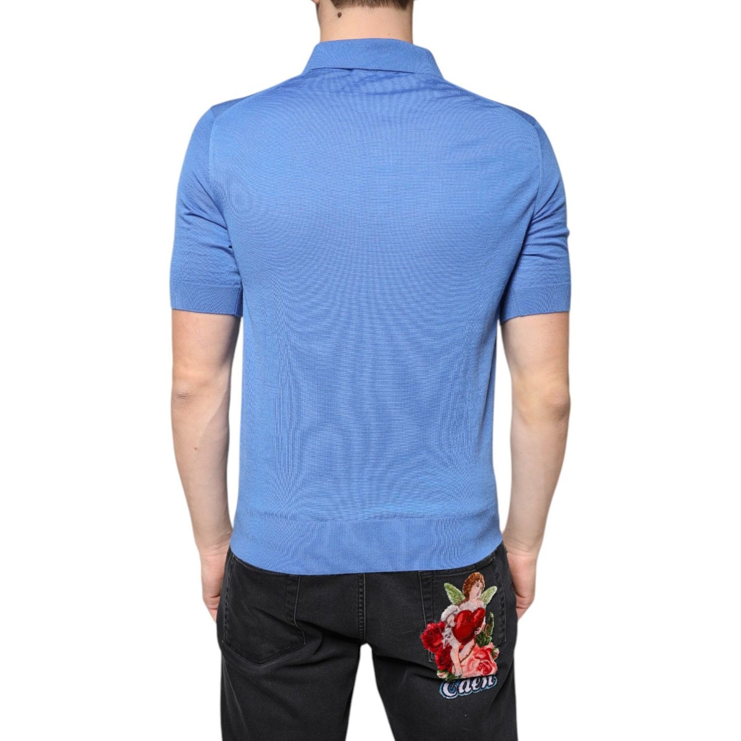 Back view of Dolce & Gabbana blue cashmere polo shirt with short sleeves, worn by a model; features a collared neck and regular fit.
