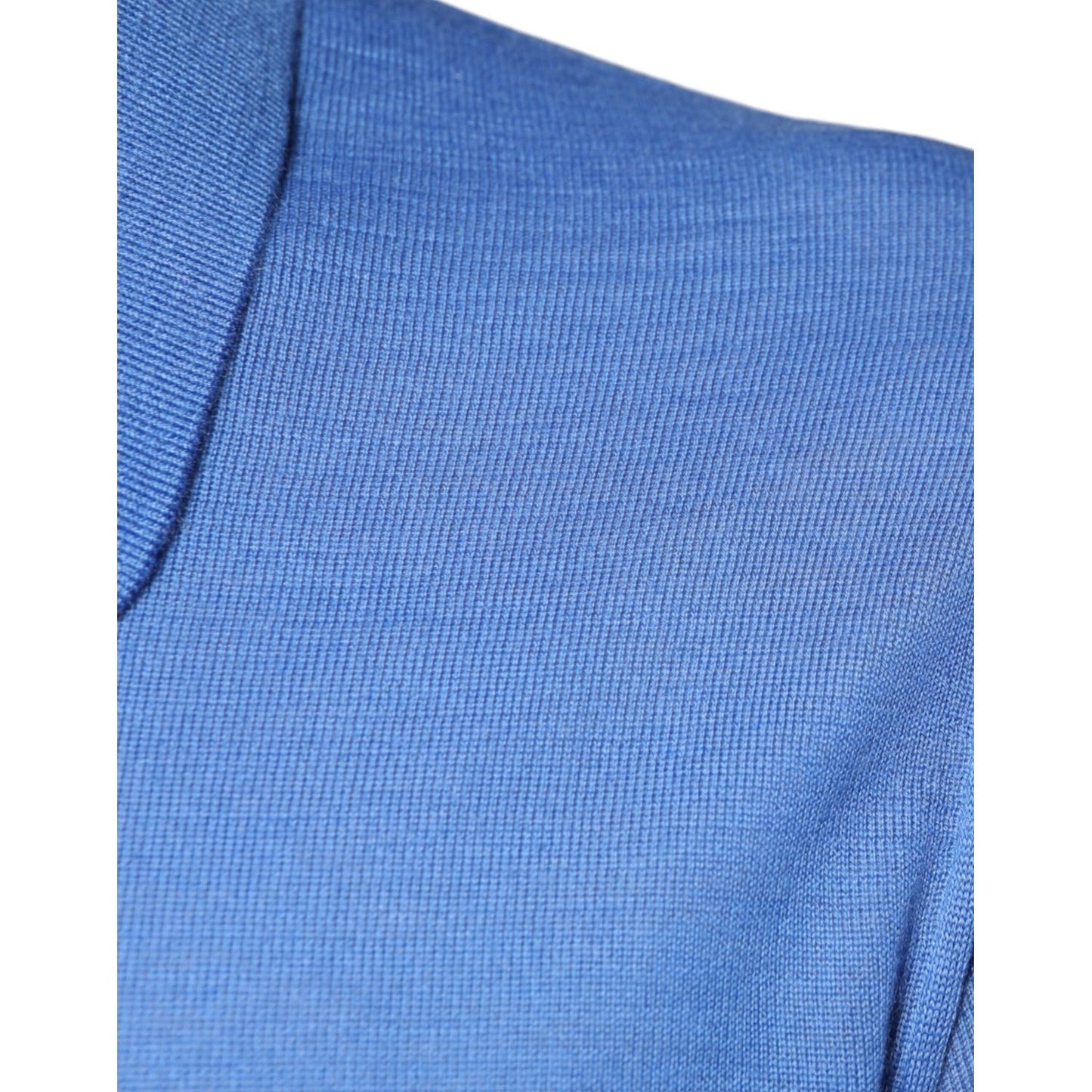 Close-up of blue cashmere Dolce & Gabbana polo shirt fabric, highlighting texture and color.