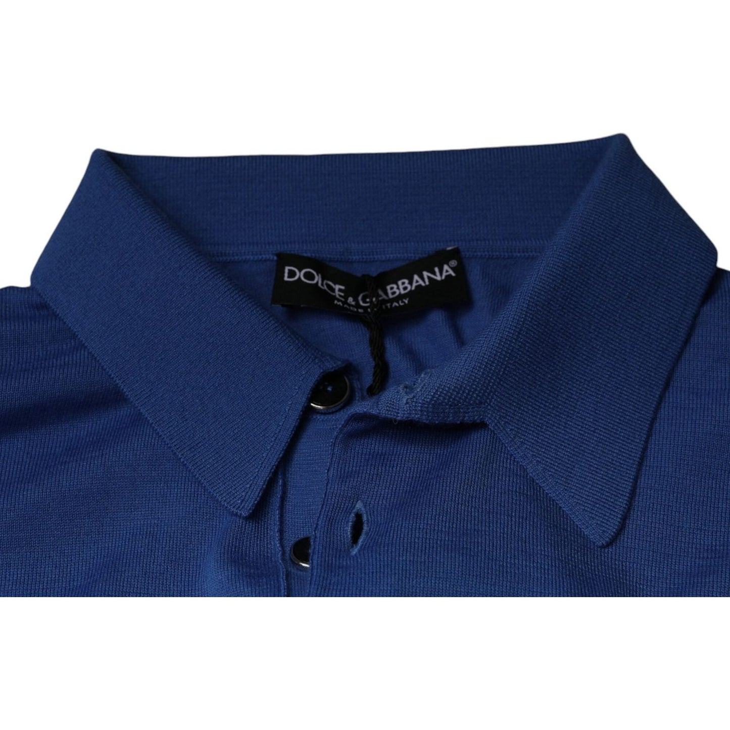 Dolce & Gabbana blue cashmere polo shirt with collar, button closure, and logo. Short sleeves, regular fit, made in Italy, minor defect visible.