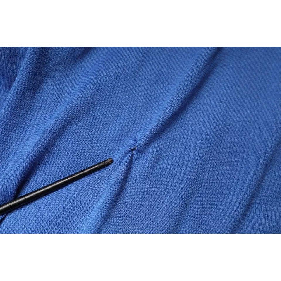 Close-up of Dolce & Gabbana blue polo shirt showing repaired rip near the front, crafted from 100% cashmere.