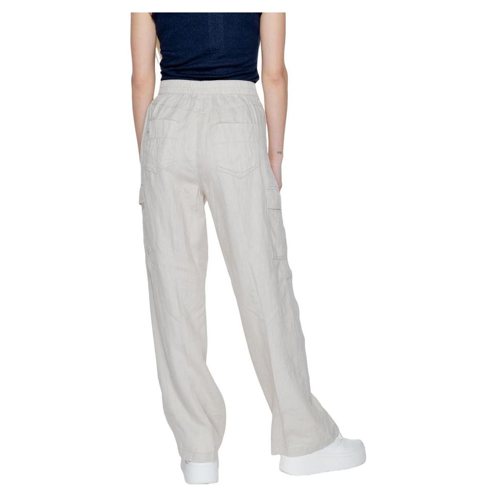 Back view of beige linen bootcut pants for women, part of Street One's Spring/Summer collection, made from 100% linen, worn with sneakers.