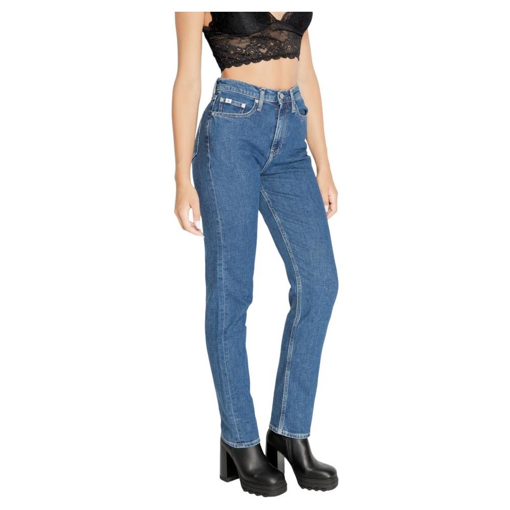 Women's Calvin Klein blue slim jeans, fall/winter collection, 79% cotton composition, modeled with black top and boots.
