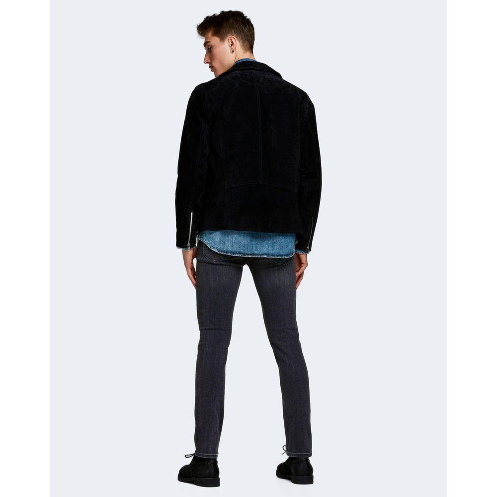 Back view of man wearing Jack Jones black organic cotton skinny jeans and a black jacket, showcasing a modern and stylish look