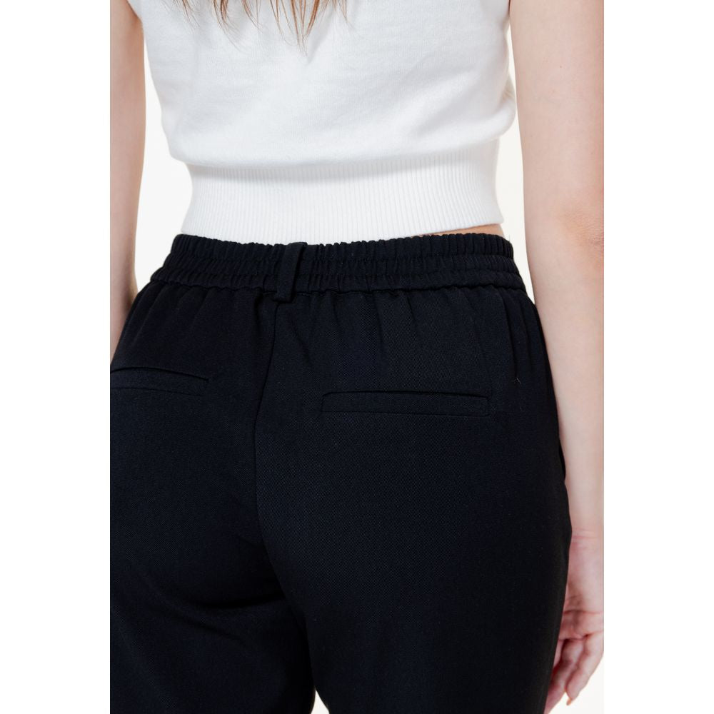 Back view of Vero Moda black polyester pants for women, showcasing elastic waistband and regular fit, part of the spring/summer collection.