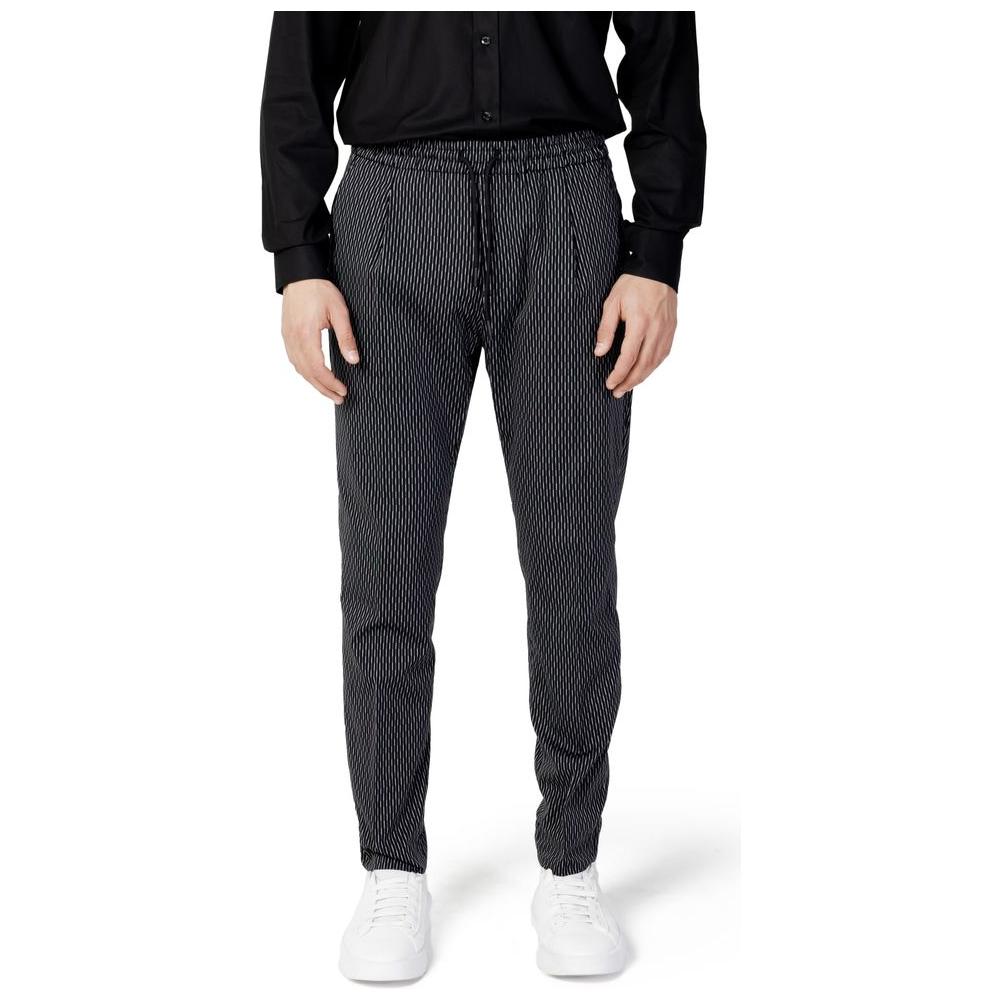 Man wearing Antony Morato black cotton jeans, model MMTR00679-FA950188, showcasing stylish regular fit with white sneakers.