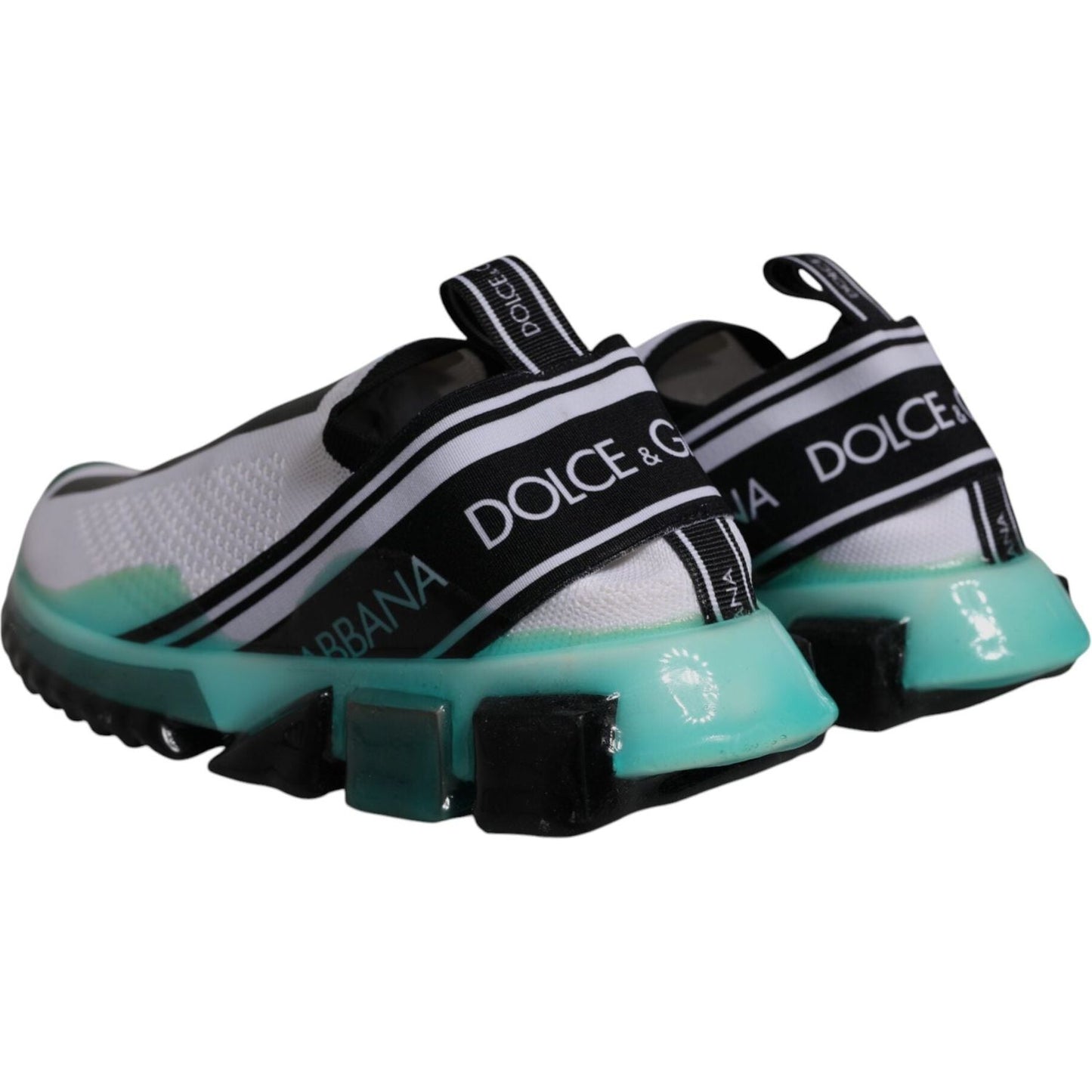 Dolce & Gabbana white and blue Sorrento slip-on sneakers with logo print, fabric strap, and multi-color rubber sole, rear view.