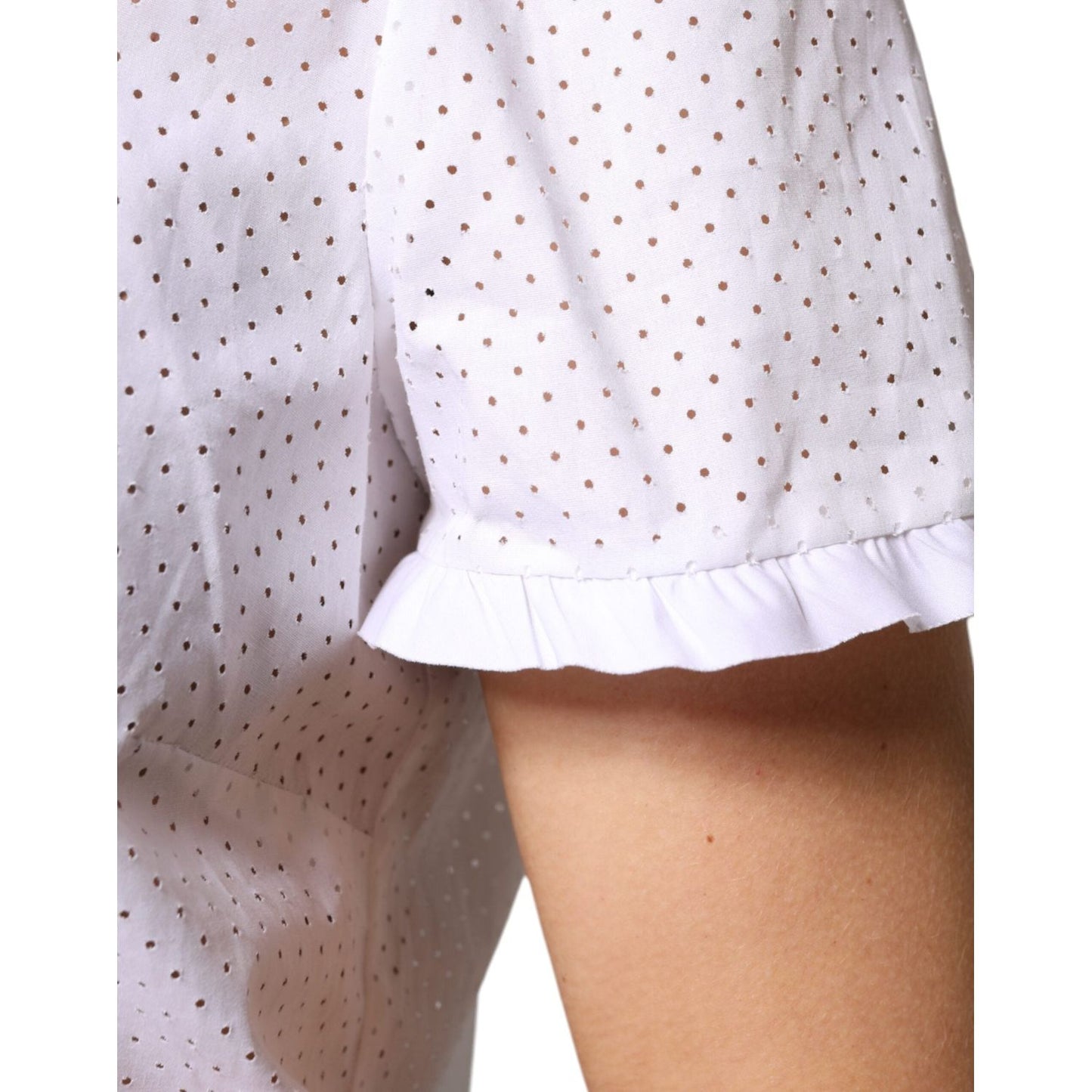 Close-up of Valentino white cotton short sleeve blouse with perforated design and ruffled edge. Minor make-up stains on collar.