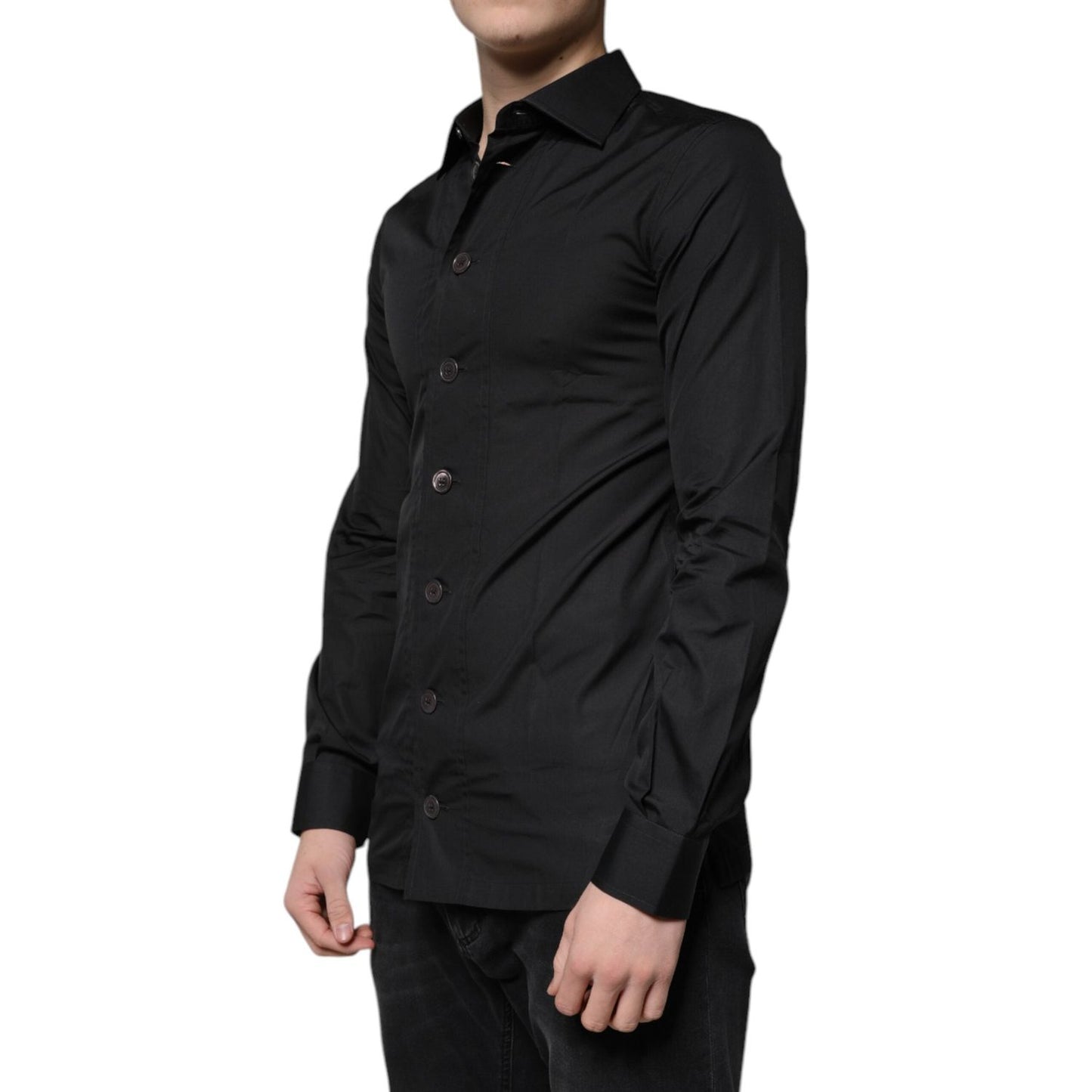 Dolce & Gabbana black cotton slim fit dress shirt with long sleeves and button-down closure, worn by a model. Made in Italy.