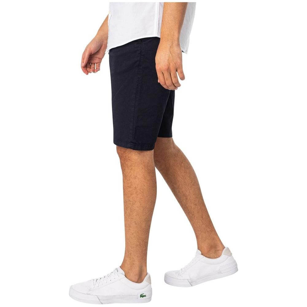 Man wearing Lyle & Scott blue cotton men's Bermuda shorts, part of Fall/Winter collection, made of 97% cotton and 3% elastane.