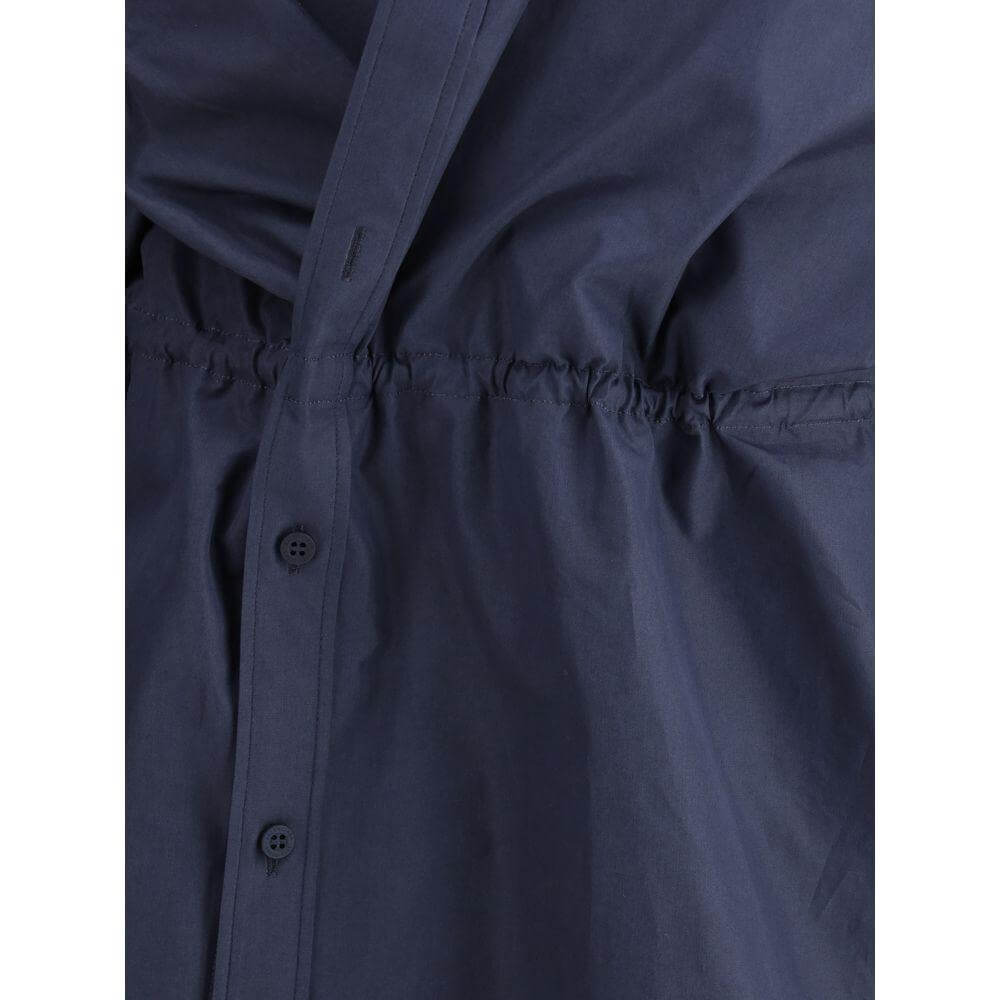 Close-up of Balenciaga Chemisier Mini Dress with drawstring waistband and asymmetrical button closure.
