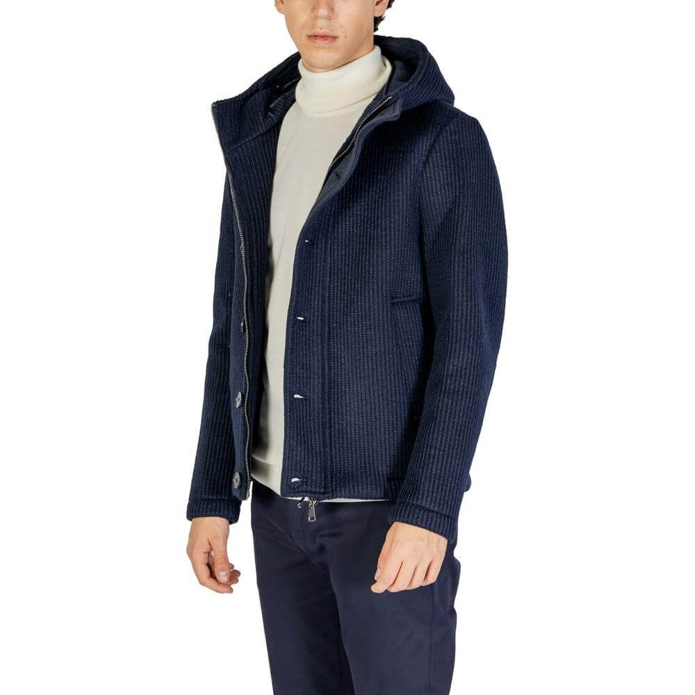 Man wearing Hydra Clothing blue polyester jacket, fall/winter collection, featuring 75% polyester and 25% wool composition.