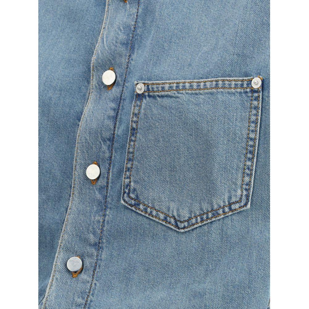 Close-up of Haikure Tamu denim dress showing snap closure and pocket detail for contemporary style.